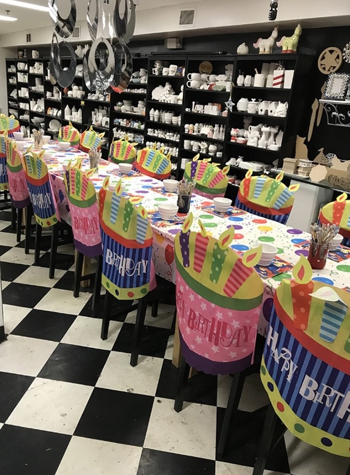 A well-organized art studio table covered with various art supplies